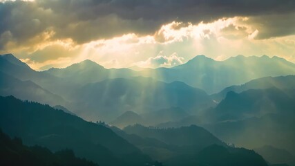 Canvas Print - First sunlight filters through clouds over mountain peaks, The first rays of light peek over the mountains