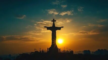 illuminated statue of jesus with glowing cross silhouette against sunset sky