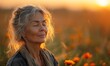 © Feeney - senior woman in a state of wellbeing in nature self healing concept with mature lady standing with eyes closed in field at sunset.