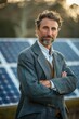 © Sunshine - Confident Middle-Aged Man in Plaid Suit Standing in Front of Solar Panels Outdoors