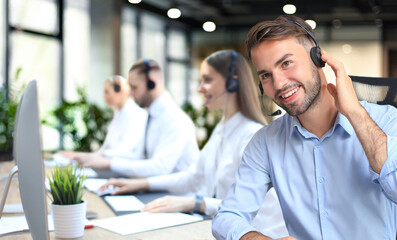 Sticker - Portrait of call center worker accompanied by his team. Smiling customer support operator at work.