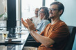 © Jacob Lund - Business team applauding and celebrating success in a meeting