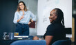 © Jacob Lund - African business woman smiling happily while sitting in a business meeting with her team