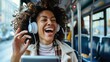 © Naknakhone - Cheerful commuter singing while using touchpad and listening music on headphones in a bus. copy space for text.