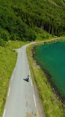 Wall Mural - discover norway stunning lovatnet lake road, where lush greenery meets tranquil blue waters, a woman