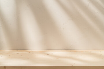 Sticker - Empty table on stucco background with natural shadow on the wall. Stylish background for branding products, presentation, food and health care.	
