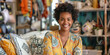 © lenblr - Portrait of a beautiful young entrepreneur smiling while sitting on a comfy couch in her home decor store