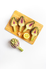 Wall Mural - Raw artichoke flower buds with garlic, cooking background