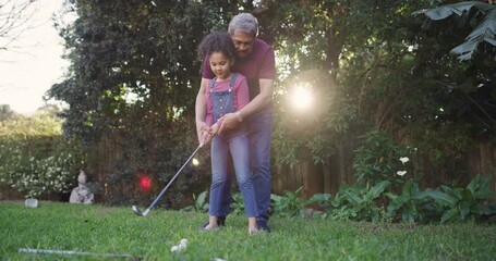 Canvas Print - Learning, teaching and bonding of a grandfather showing a little girl a golf player swing outside. Active, playing and leisure activity of a loving family having fun together in an outdoor garden