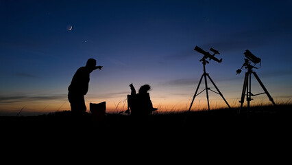 Wall Mural - people enjoying watching and stargazing with astronomy telescopes outdoors in nature, observing plan