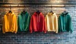 © TigerDude - A set of plain colored hoodies hanging on the brick wall, showcasing different colors and styles for product presentation mockup. Mock-up templat