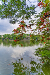 Hoan Kiem lake or Sword lake, Ho Guom in Hanoi, Vietnam with Turtle Tower, on clear day with blue sky and white clouds