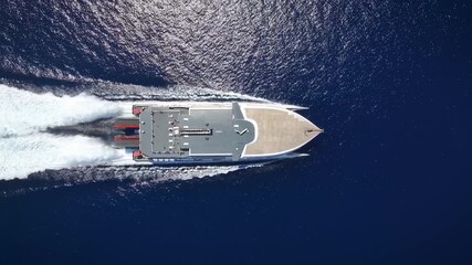 Wall Mural - aerial top down view of a catamaran jet passenger ferry boat traveling with high speed over the ocea