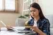 © Pormezz - young asian woman cover her face after stressed with monthly bill expenses and credit card debt.