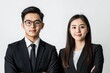 © MUdaylah - Photo of two young Asian business people on white background with generative ai