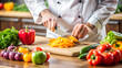 © PETR BABKIN - The cook cuts vegetables on a cutting board.
