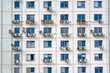 © Tricky Shark - Multiple air conditioning units mounted on the facade of building with numerous windows, cooling systems in urban architecture. Air conditioning units on exterior building wall.