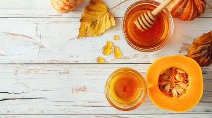 Wall Mural - Autumn themed fresh pumpkin drizzled with honey on white wooden backdrop viewed from above Ample space available