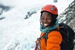 © GoodandEvil - Woman climber in orange jacket and red helmet