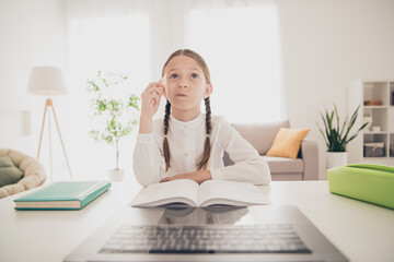 Wall Mural - Photo of cute small girl think study online laptop video call desk modern apartment indoors