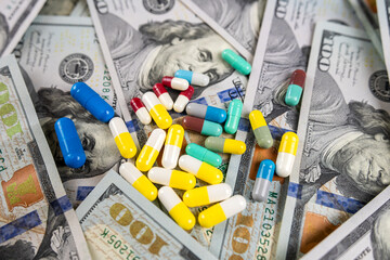 Wall Mural - different pills for treatment lying on us dollar banknotes