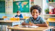 © InspireStock Gallery - Happy African American schoolboy sitting at desk in elementary school classroom, with copy space for text , education, student