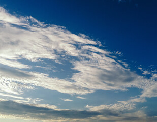 Wall Mural - The sky is blue with a few clouds scattered throughout