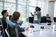 © Mediteraneo - African American woman CEO talking on meeting with her colleagues about business plan, future collaboration.