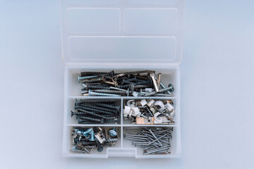 Open plastic box with special compartments for screws and nails.