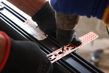 Wall Mural - Repairman installing new window with electric screwdriver indoors, closeup