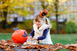 © Irina Schmidt - Little toddler girl dressed as a witch trick or treating on Halloween. Happy child outdoors, with orange funny hat and pumpkin bag for sweet haunt. Family festival season in october. Outdoor activity