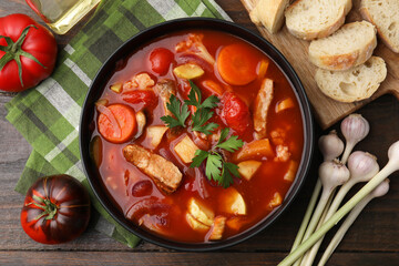 Wall Mural - Tasty homemade stew with vegetables on wooden table, flat lay