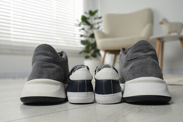 Sticker - Big and small sneakers on floor indoors