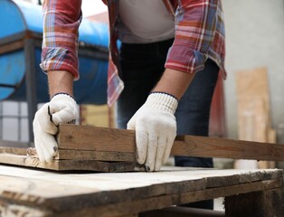 Wall Mural - Man working with wood in backyard, closeup