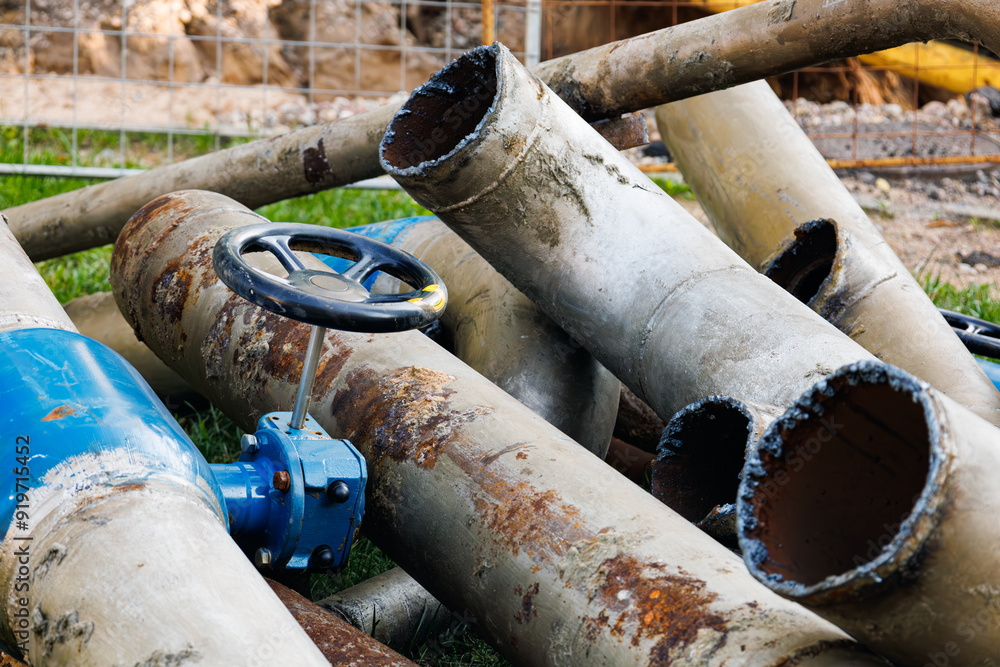 Wate Pipe Rots Water pipe replacement. Fragment of old rusty water pipes. Destroyed ...