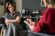 © Mediaphotos - Attentive woman sitting during a counseling session with attentive counselor in a cozy office setting focusing on mental health and well-being