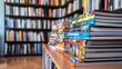 © fivan - A colorful stack of graphic novels with bold, eye-catching covers, arranged on a modern bookshelf