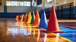 © chutikan - Colorful cones on the gym floor, a sport for children to practice physical education learning skills in school.