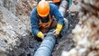 © fivan - A construction worker installing underground pipes for a sewer system