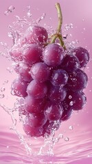 Poster - Bunch of red grapes splashing into water with water droplets falling and a pink background.