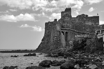 Sticker - Ruins of a Norman castle on a volcanic cliff in the village of Aci Castello on the island of Sicily