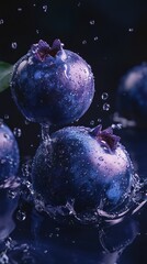 Wall Mural - Close-up of two blueberries in water with water droplets splashing around them, one blueberry is on top of the other.