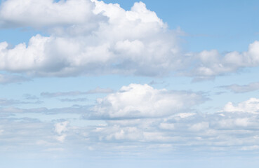 sky replacement white puffy clouds against very light blue sky
