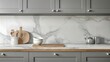 © anong - Front view of elegant interior with gray drawers under kitchen cabinet. empty wooden table and marble countertop in room. modern equipment for cooking.