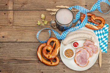 Wall Mural - Traditional Oktoberfest set. Pretzels, beer, weisswurst, eisbein with mustard. German festival food