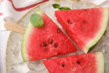 Wall Mural - Pieces of tasty watermelon, ice cubes and mint on table, top view