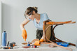 © Maria Vitkovska - Woman using chisel restoring old wooden chair at home