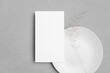 © nikavera - Wedding menu card mockup with white plate and dry grass decoration, blank mockup with copy space
