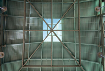 Teal Metal Roof with a Skylight and a Cantilever Support Structure.