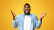 © Prostock-studio - I can not believe. Portrait of joyful african american man raising hands in the air with excitement and looking at camera, yellow studio background.